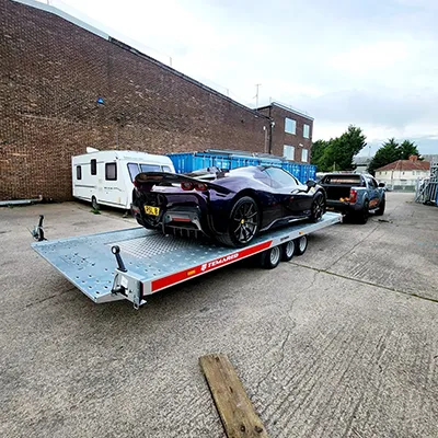 a car being towed on a flatbed trailer