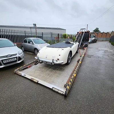 a car being loaded onto a flatbed trailer