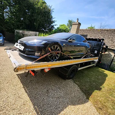 a car being towed on a flatbed tow truck