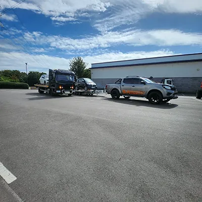 a couple of trucks parked next to each other in a parking lot